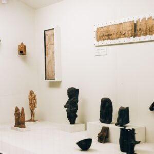 A collection of ancient figurines and artifacts on display in a museum exhibit.